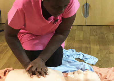 Bromley Park staff member doing chest compressions on a first aid CPR dummy