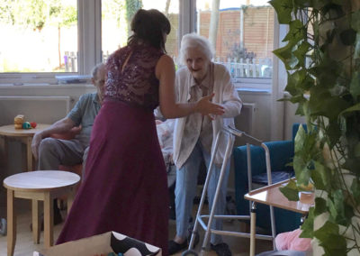 A singer and lady resident dancing together at Bromley Park Care Home