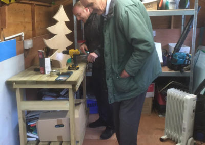 Resident and staff member in the shed together at Bromley Park Care Home
