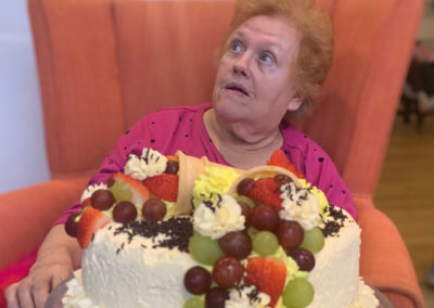 Resident sitting with her birthday cake