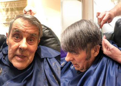A gentleman resident at Bromley Park having his hair done by Hairdresser Rob