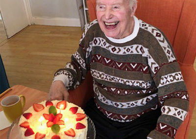 Resident receiving his birthday cake at Bromley Park