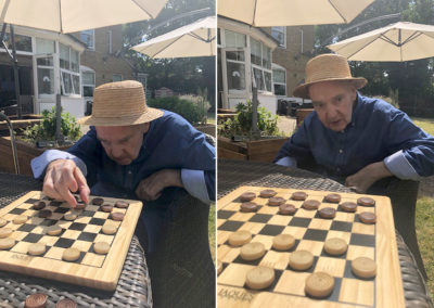 Bromley Park Care Home resident playing draughts in garden